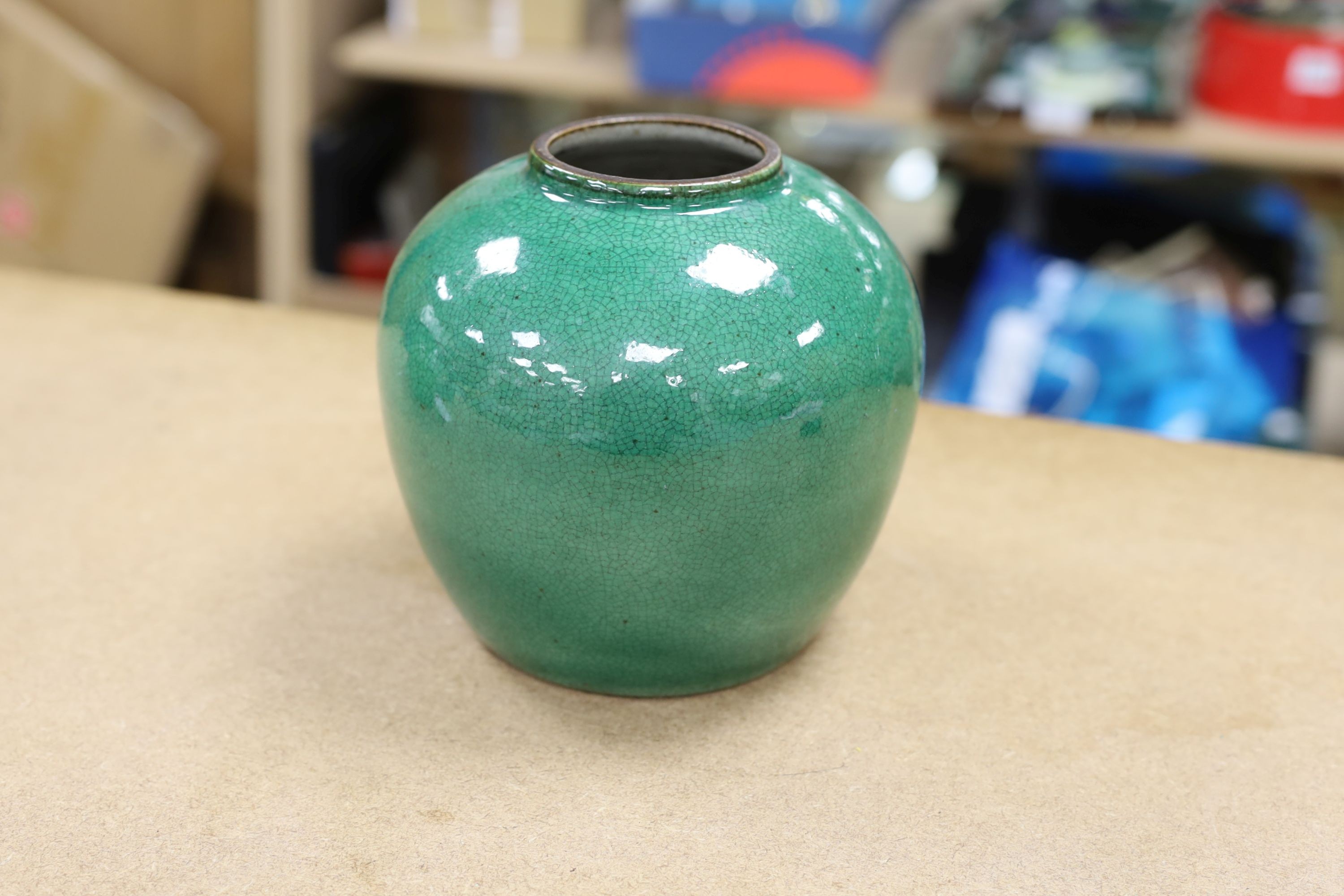 A 19th century Chinese green glazed model of a lion-dog, and two green crackle glaze jars, tallest 16cm